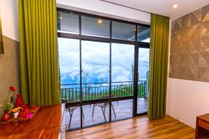 a room with a large window with a view of a balcony at leisure Mount View in Haputale