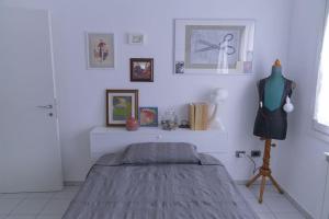 a bedroom with a bed in a white room at La Casa di Alice, comfort tra Modena e Maranello in Montale +6 photos