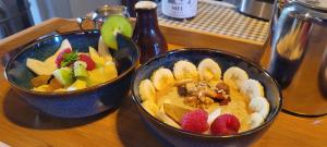 two bowls of fruit on a wooden table at House of Moitelas 