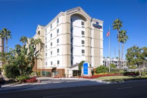Un edificio con una bandiera americana davanti di Candlewood Suites Anaheim - Resort Area, an IHG Hotel ad Anaheim
