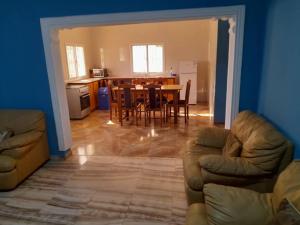 a living room with a table and a dining room at Bijilo Villa in Bijilo
