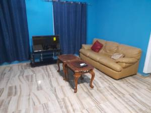 a living room with a couch and a coffee table at Bijilo Villa in Bijilo