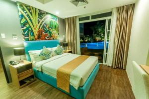 A bed or beds in a room at Aziza Paradise Hotel