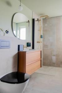 a bathroom with a tub and a sink and a mirror at Margretetorps Gästgifvaregård in Vejbystrand