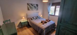 a bedroom with a bed with a teddy bear on it at Rincón de Elena in Quéntar +59 photos