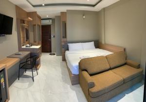 a bedroom with a bed and a couch and a sink at HEAVEN HILL LANTA in Ko Lanta