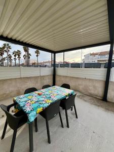 a table and chairs on a balcony with a view at Petite maison à 100m de la plage in Marseillan +9 photos