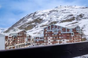 a group of buildings in front of a snow covered mountain at Belambra Clubs Tignes Val Claret in Tignes