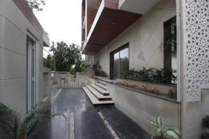 a house with stairs and plants on the side of it at Hotel Elite Millennium - Near Huda City Centre Gurgaon in Gurgaon