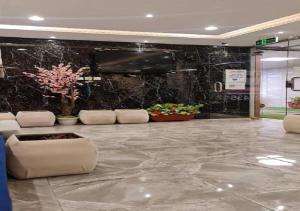 a lobby with a large marble floor with a flat screen tv at SNOW CLOUD in Abha