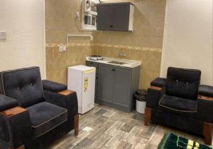 a waiting room with two chairs and a sink at SNOW CLOUD in Abha