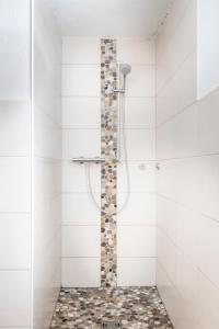 a bathroom with a shower with white tiles at Hauserlhütte in Zederhaus