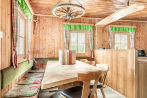 a dining room with a wooden table and chairs at Hauserlhütte in Zederhaus