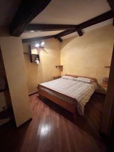 a bedroom with a bed and a wooden floor at B&B Borgata 2000 in Borgata Sestriere