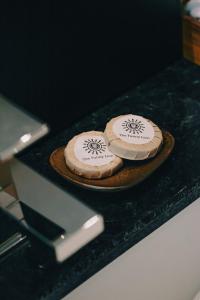 two pizzas sitting on a plate on a counter at The Funny Lion - Puerto Princesa in Puerto Princesa City