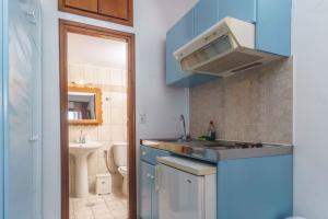a small kitchen with a sink and a toilet at Galini Apartments in Lentas
