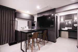 a kitchen with a table and chairs in a room at XYM Hotel Mundeok in Pohang