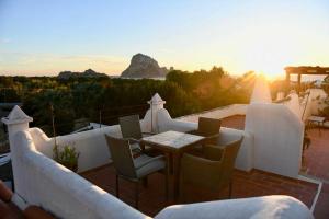 a patio with a table and chairs with a view at apartment with magnificient Es Vedra view in Cala Vadella