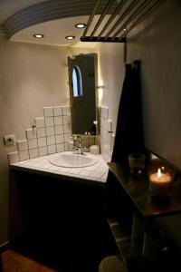 a bathroom with a sink with a mirror and a candle at apartment with magnificient Es Vedra view in Cala Vadella