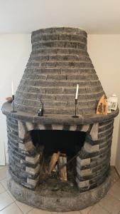 a stone fireplace with two candles on top of it at Stephanie Residence - in the heart of Alps above Varenna, Lake Como in Esino Lario