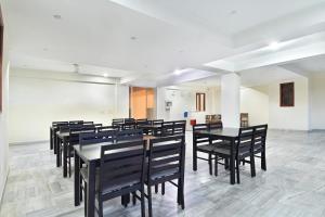 a group of tables and chairs in a room at Gulmohar inn in Lucknow