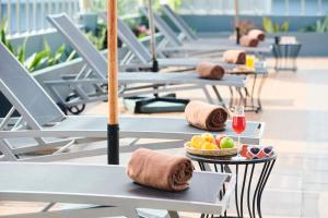 a row of tables with bowls of fruit on them at Adelphi Pattaya - SHA Extra Plus in Pattaya Central