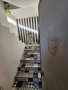 a staircase with black and white tiled floors next to a door at wanderlust in Pomezia