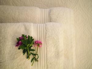 a bouquet of pink flowers sitting on a towel at St. George Liston Suite in Corfu