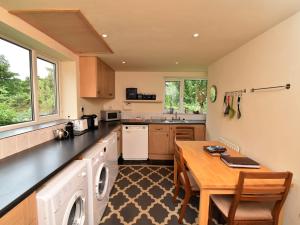 a kitchen with a table and a counter top at 3 Bed in Holmrook SZ272 in Holmrook