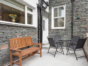 a bench on a patio with a table and chairs at 3 Bed in Keswick SZ030 in Keswick