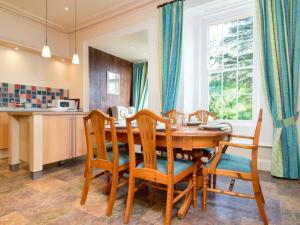 a dining room with a wooden table and chairs at 3 Bed in Applethwaite SZ168 in Applethwaite