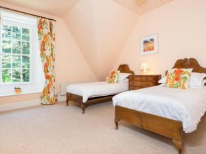 two beds in a room with a window at 3 Bed in Applethwaite SZ168 in Applethwaite
