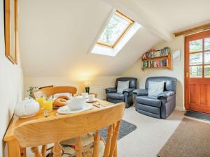 a living room with a table and a couch at 1 Bed in Ullswater SZ295 in Dockray