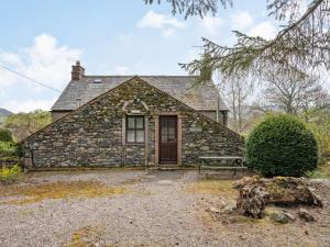 a stone house with a bench in front of it at 1 Bed in Ullswater SZ295 in Dockray