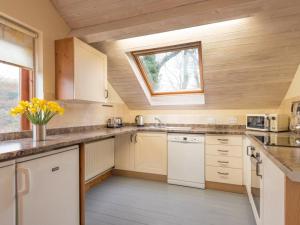 a kitchen with white cabinets and a window at 2 Bed in Bassenthwaite SZ381 in Bassenthwaite Lake