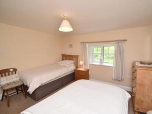 a bedroom with two beds and a window at 3 Bed in Newlands Valley SZ075 in Borrowdale