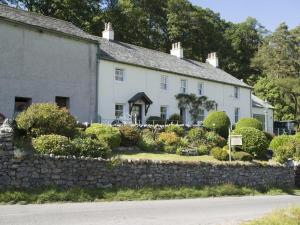 a large white house with a stone wall at 3 Bed in Newlands Valley SZ075 in Borrowdale