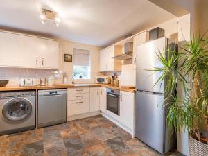 a kitchen with white cabinets and stainless steel appliances at 3 Bed in Gosforth SZ064 in Gosforth