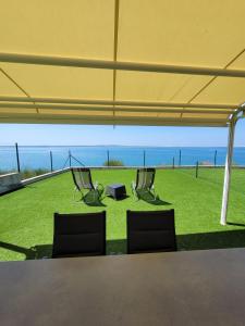 two chairs and a table under a tent at Apartment Toth - Rtina Benići in Rtina