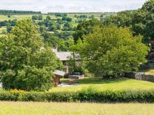 a house in the middle of a field with trees at 2 Bed in Bampton SZ271 in Bampton