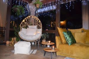 a living room with a couch and chairs and lights at Holiday, party and relax vila 