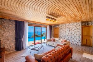 a living room with a couch and a view of the ocean at Villa Ahenk / Faralya in Fethiye
