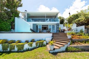 a house with a view of the backyard at Sea Haven - Bakoven Beach Front Villa in Cape Town