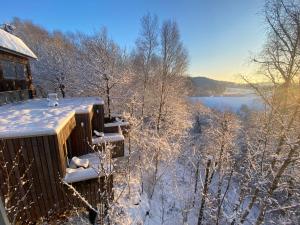 a cabin in the snow with a view of a lake at CHAMBRES PERCHEES in Waimes