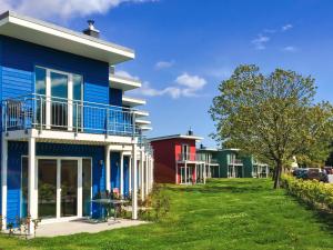 a row of colorful houses in a park at Ferienhauspark Asgard in Damp in Damp +45 photos