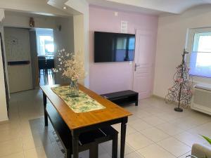 a dining room with a table with a vase of flowers on it at "Les Tournesols" in Saint-Martin-dʼArdèche