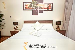 a bedroom with a bed with white sheets at Beach bliss 3BR apartment Corniche in Abu Dhabi