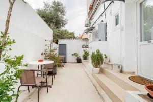 an outdoor patio with a table and chairs and plants at Cozy and Traditional EC Studios in Larnaka