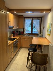 a kitchen with wooden cabinets and a table and chairs at Ferienhaus Fichte in Todtmoos