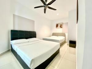 a bedroom with two beds and a ceiling fan at Mansion One George Town in George Town +74 photos